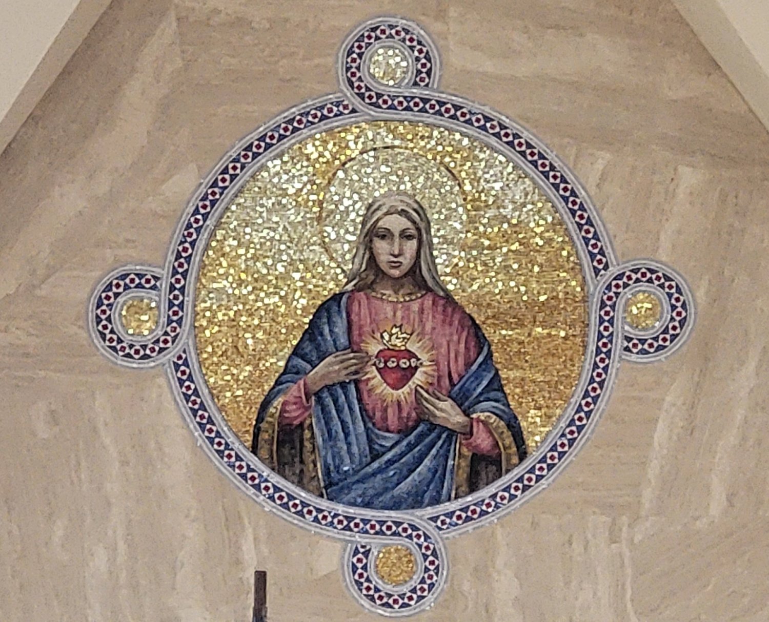 This radiant mosaic image of the Immaculate Heart of Mary adorns the travertine marble wall behind the sanctuary of the Cathedral.